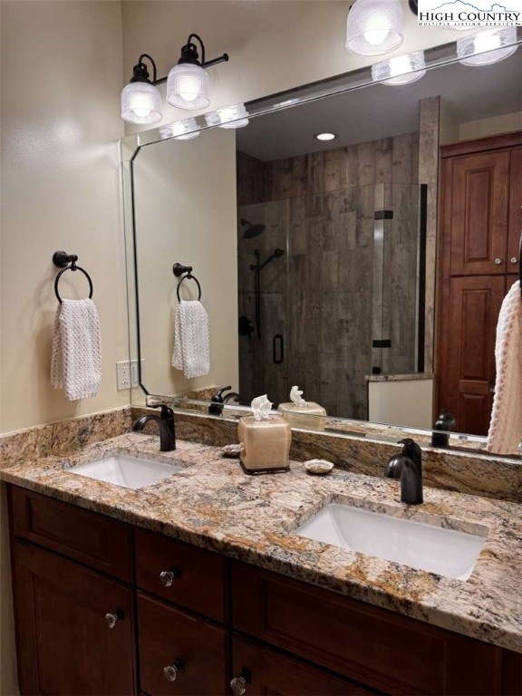 167 Elliott Circle, Unit D1 Blowing Rock, NC 28605 - Photo 10 of 25 a bathroom with a granite countertop sink and a mirror