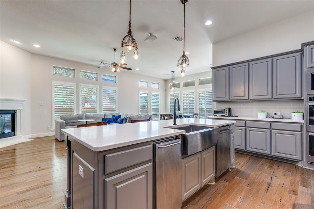 15193 Basket Oak Road Frisco, TX 75035 - Photo 40 of 40 a kitchen with a stove sink and wooden floor