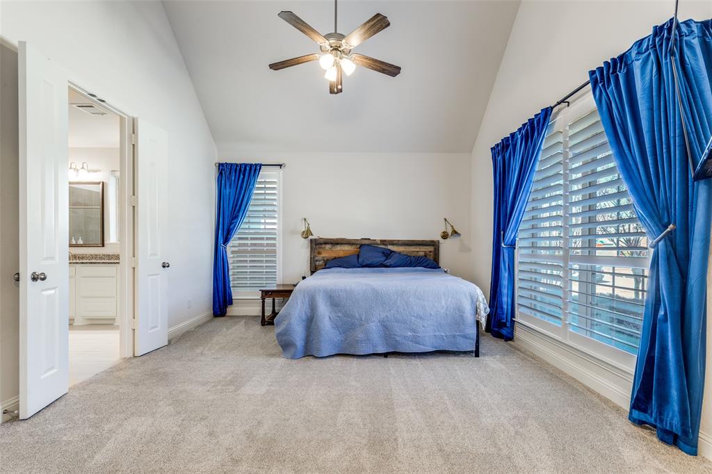 15193 Basket Oak Road Frisco, TX 75035 - Photo 15 of 40 a bedroom with a bed and a chandelier