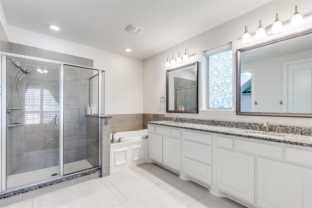 15193 Basket Oak Road Frisco, TX 75035 - Photo 16 of 40 Bathroom with double vanity, a stall shower, and a garden tub