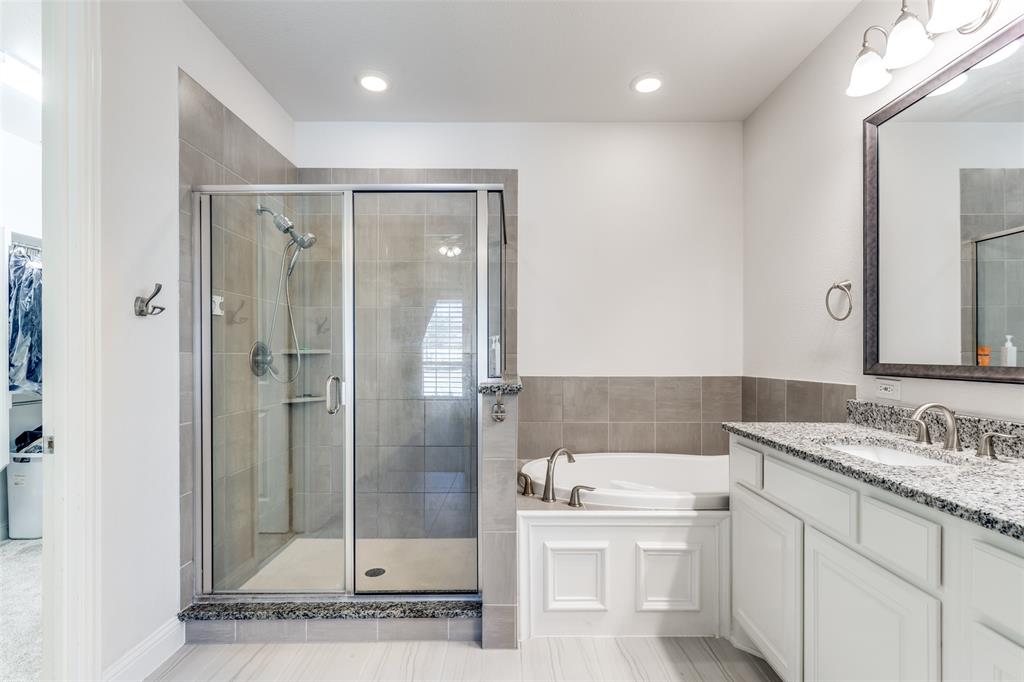 15193 Basket Oak Road Frisco, TX 75035 - Photo 16 of 40 a bathroom with a sink a toilet and shower