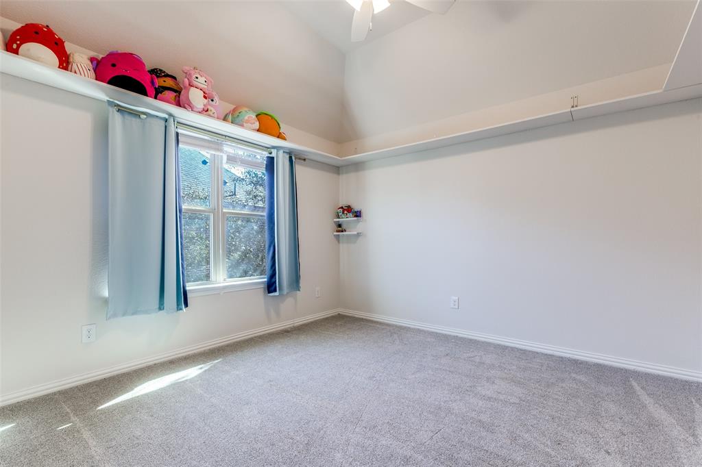 15193 Basket Oak Road Frisco, TX 75035 - Photo 21 of 40 Carpeted empty room featuring baseboards and a ceiling fan