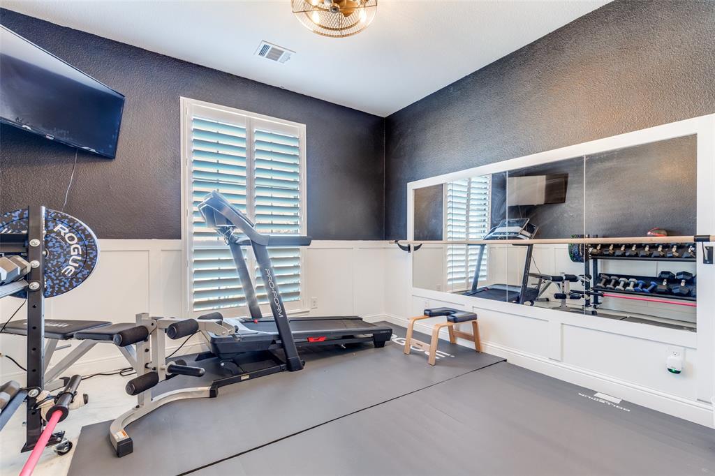 15193 Basket Oak Road Frisco, TX 75035 - Photo 22 of 40 Workout room featuring a decorative wall, a textured wall, and a wainscoted wall
