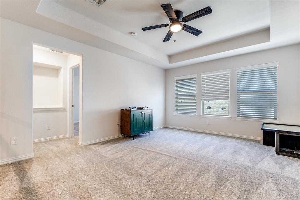15193 Basket Oak Road Frisco, TX 75035 - Photo 23 of 40 Empty room with a tray ceiling, a ceiling fan, and light colored carpet