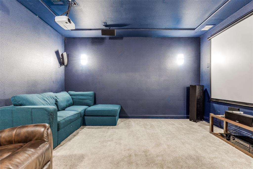 15193 Basket Oak Road Frisco, TX 75035 - Photo 24 of 40 Carpeted cinema room featuring a textured wall and a textured ceiling
