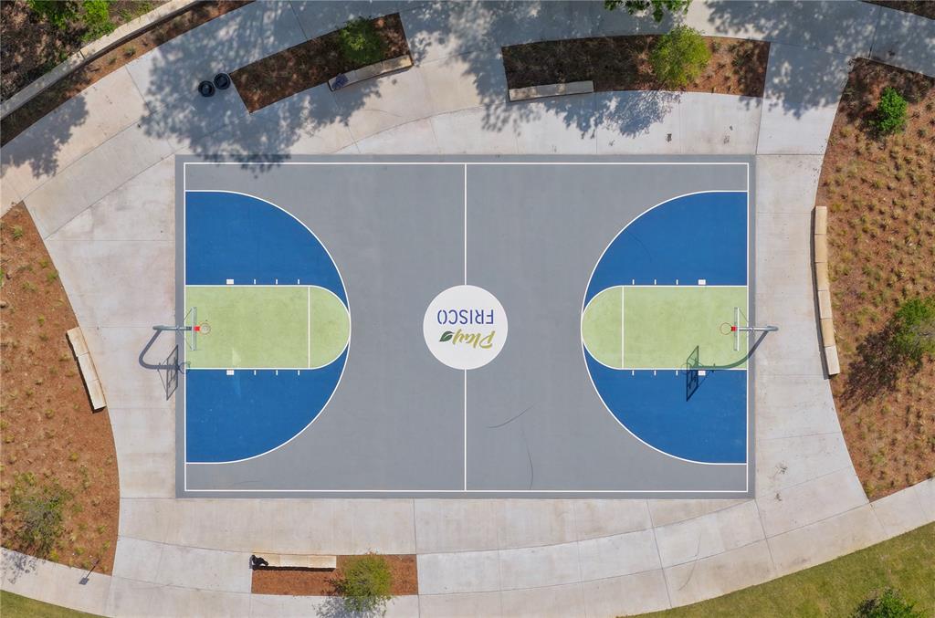 15193 Basket Oak Road Frisco, TX 75035 - Photo 33 of 40 The community amenities include a basketball court with blue and light green markings on a grey surface