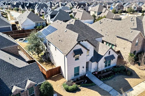 an aerial view of a house with a yard