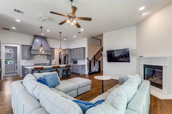 a living room with furniture kitchen view and a fireplace