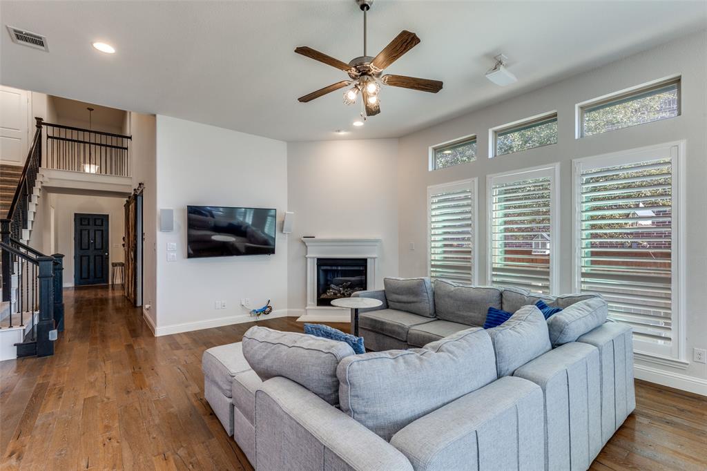 15193 Basket Oak Road Frisco, TX 75035 - Photo 6 of 40 a living room with furniture floor to ceiling window and a flat screen tv
