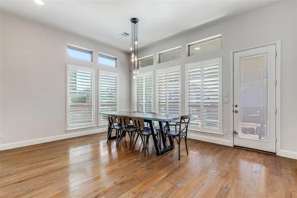 an empty room with wooden floor and furniture