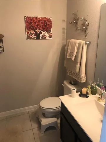 a bathroom with a sink mirror vanity and toilet