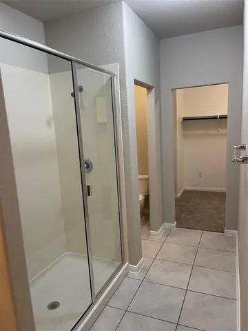 a bathroom with a shower and toilet