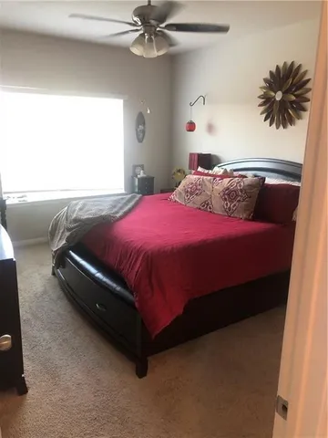 a bedroom with a bed and window