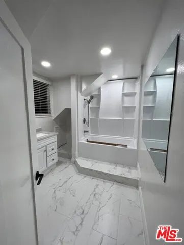 a bathroom with a sink and a shower