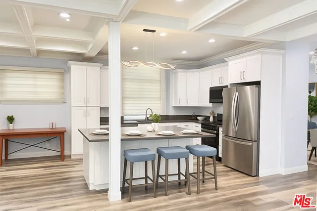 a kitchen with refrigerator cabinets and wooden floor