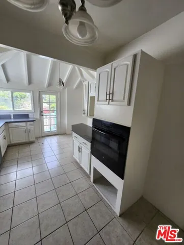 a kitchen with stainless steel appliances granite countertop a stove a microwave and a sink