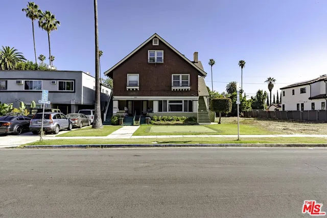a view of a house next to a yard