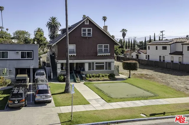 a front view of a house with garden