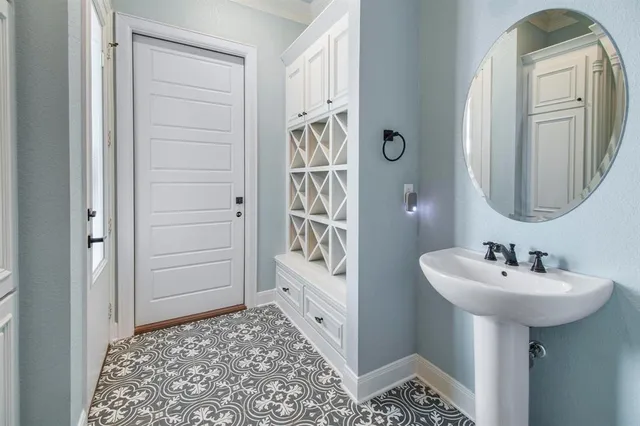 a bathroom with a sink a mirror and a shower