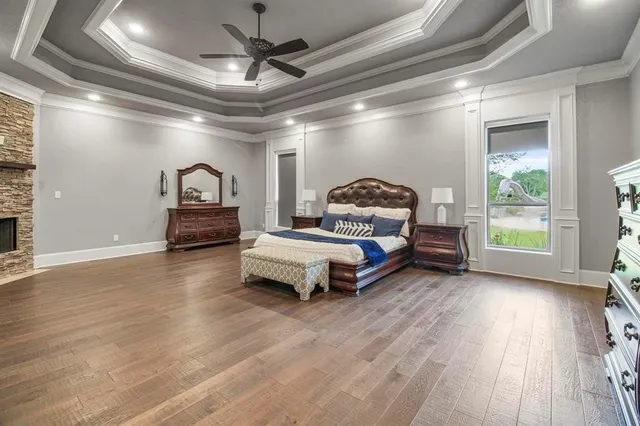 a bedroom with furniture and wooden floor