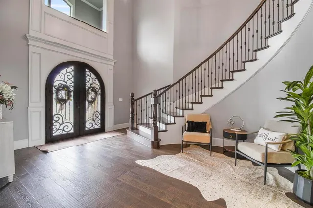 a view of entryway and hall with wooden floor