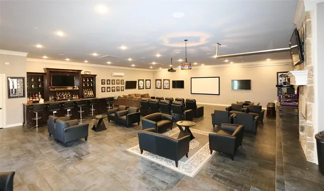 a living room with furniture kitchen view and a refrigerator