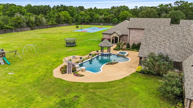 a view of a swimming pool with a yard