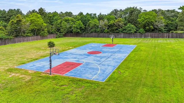 a view of a backyard with swimming pool of grass and a yard