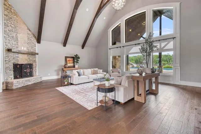 a living room with furniture a fireplace and wooden floor