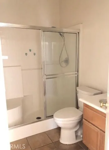 a bathroom with a toilet and shower