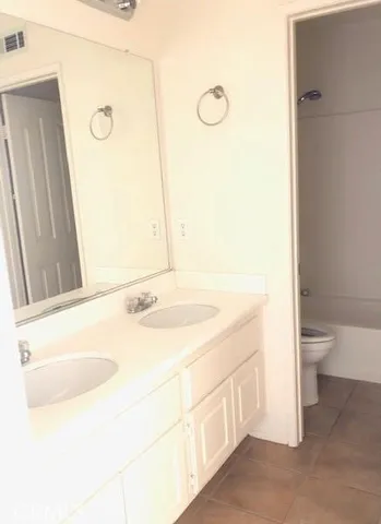 a bathroom with a sink a toilet and mirror