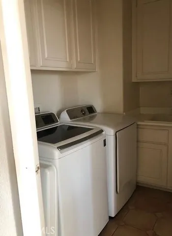 a utility room with sink dryer and washer