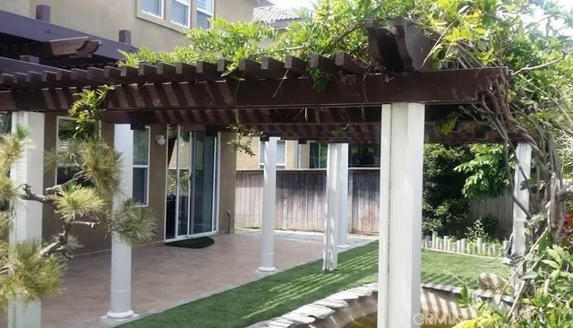 a view of a house with a small yard and potted plants