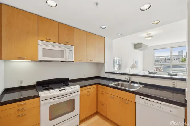 a kitchen with granite countertop a sink and cabinets