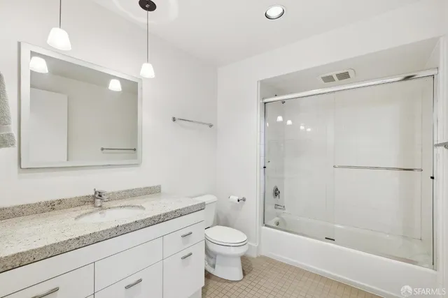 a bedroom with bed chair and couch