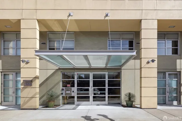 a view of a street with chairs in front of it