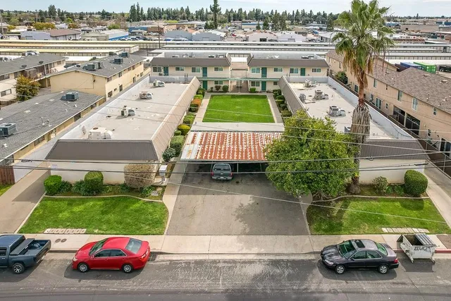 an aerial view of a house with a garden and parking space