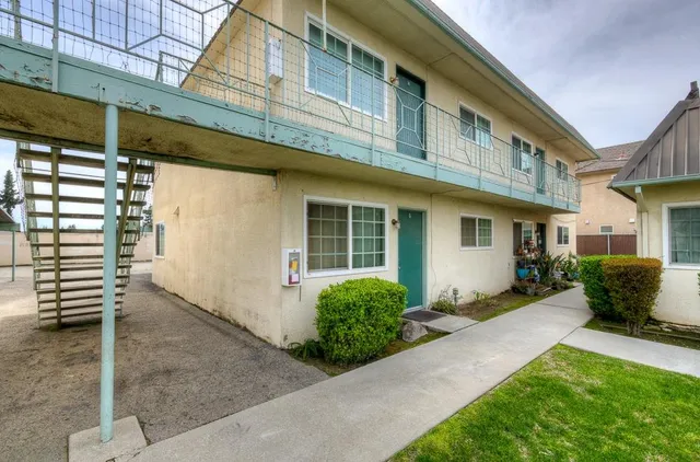a front view of a house with a yard outdoor seating and garage