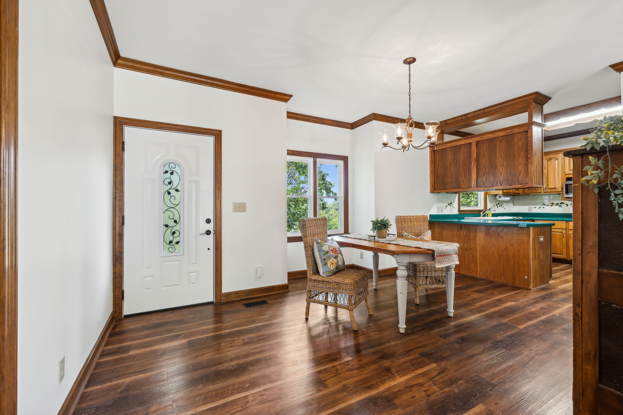 1712 Sugar Ridge Road Spring Hill, TN 37174 - Photo 11 of 65 a dining room with wooden floor a chandelier a wooden table and chairs
