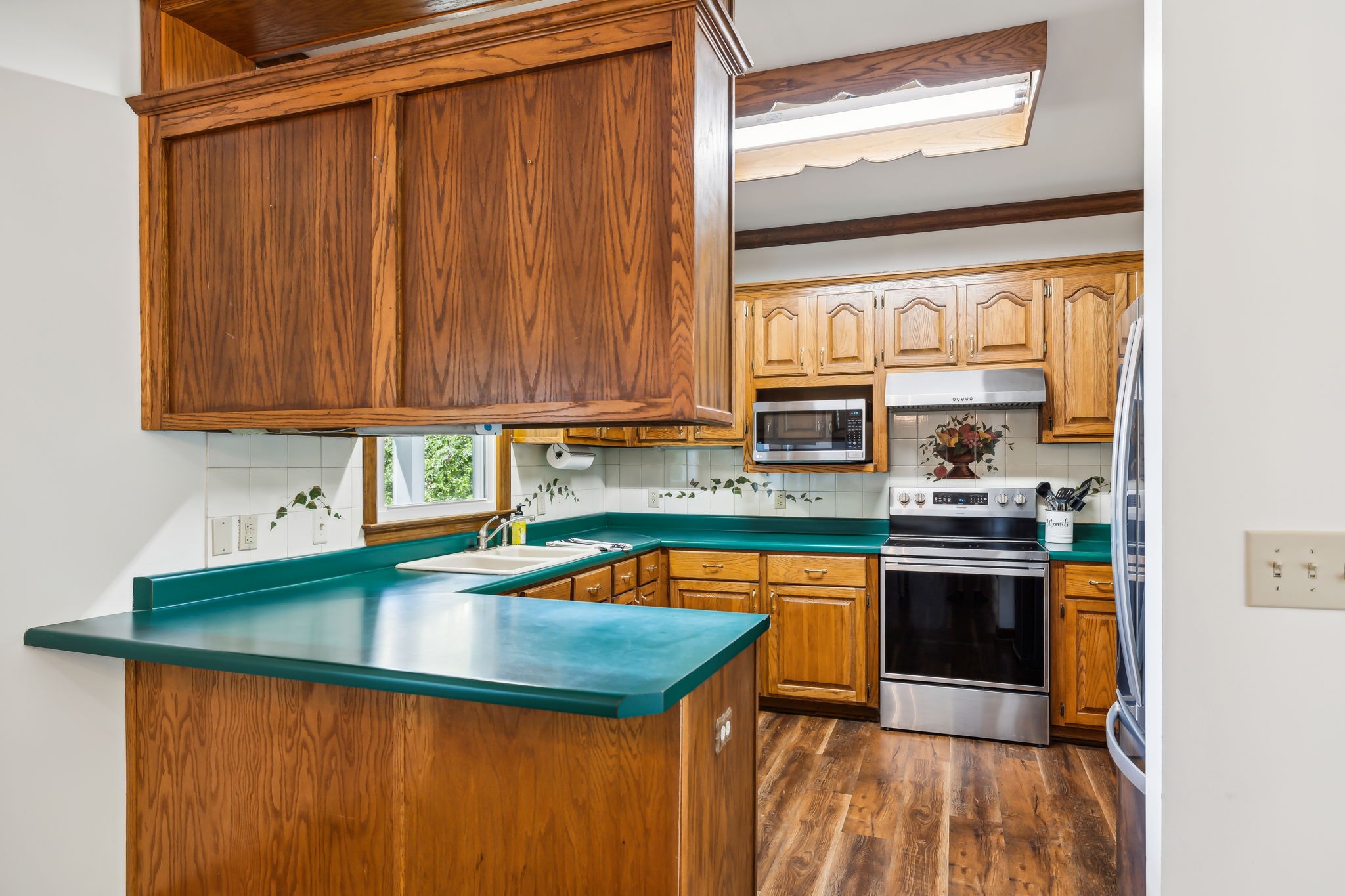 1712 Sugar Ridge Road Spring Hill, TN 37174 - Photo 19 of 65 a kitchen with stainless steel appliances granite countertop a sink a stove and a microwave