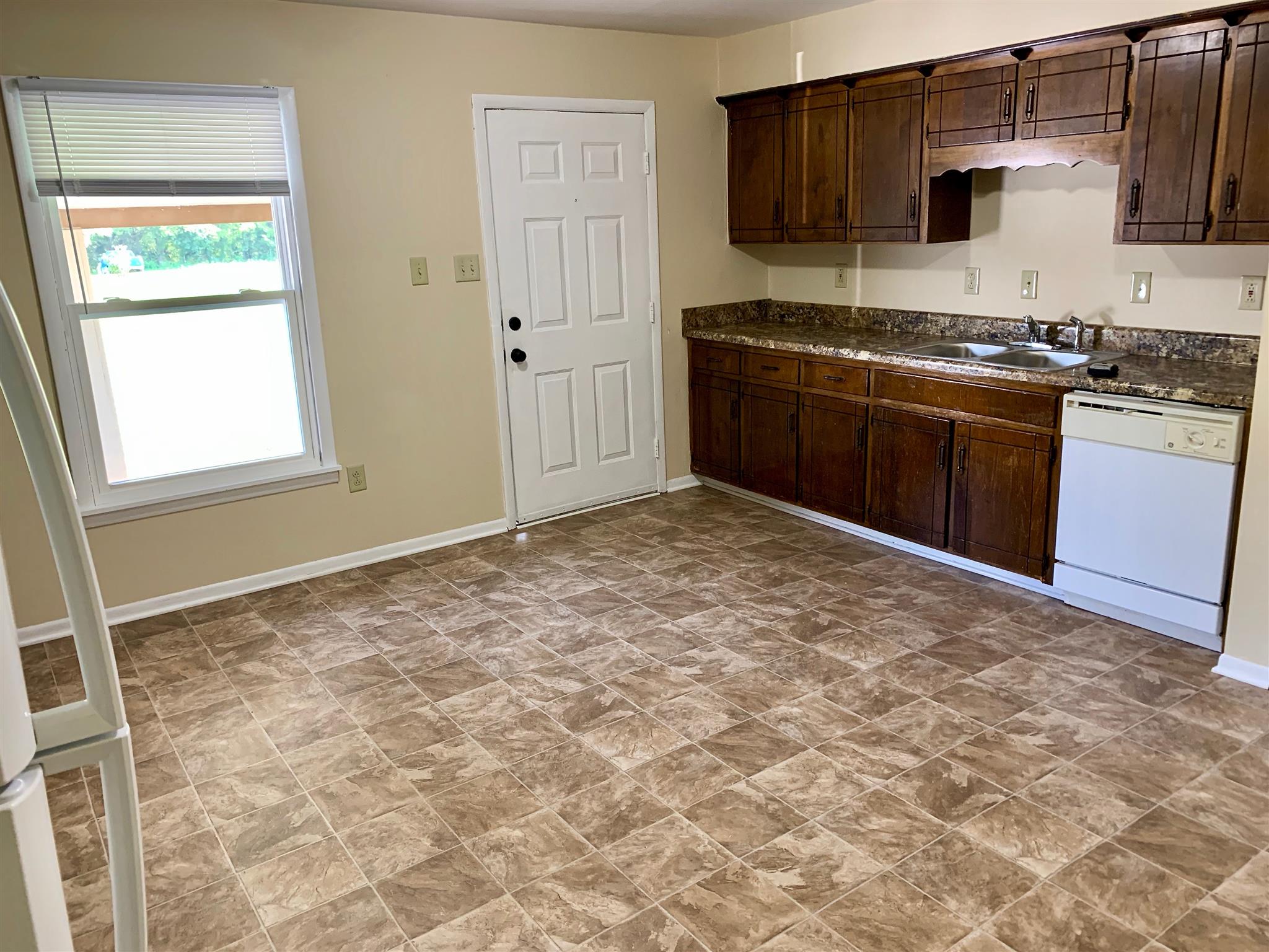 1163 Lawrence Road Murfreesboro, TN 37128 - Photo 5 of 12 Wooden cabinets and new vinyl! Front door located in the kitchen! 1163 Lawrence Rd Murfreesboro TN 37128