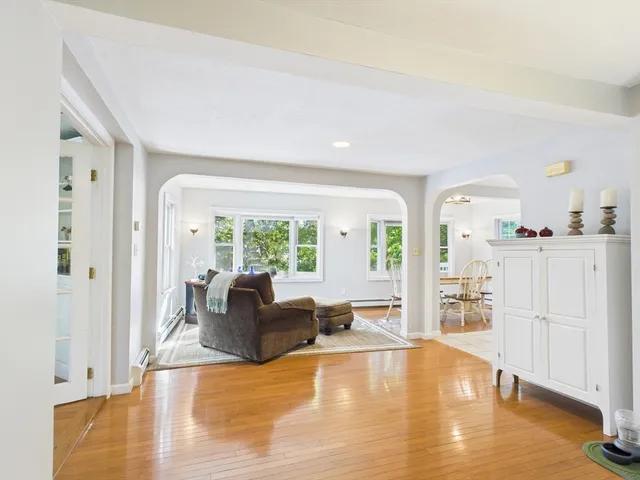 a living room with furniture and large windows