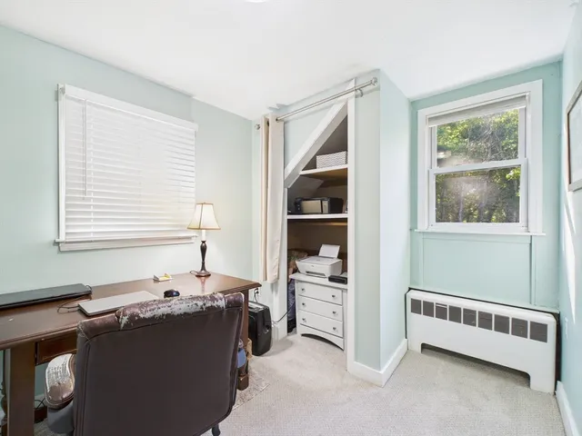 a view of workspace with wooden floor and window
