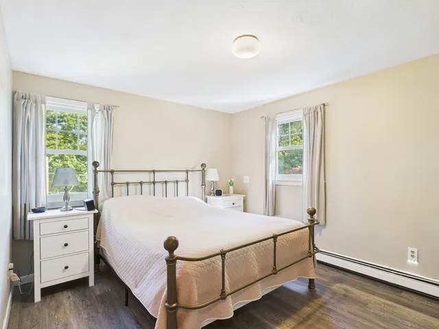 a bed sitting in a bedroom next to a window