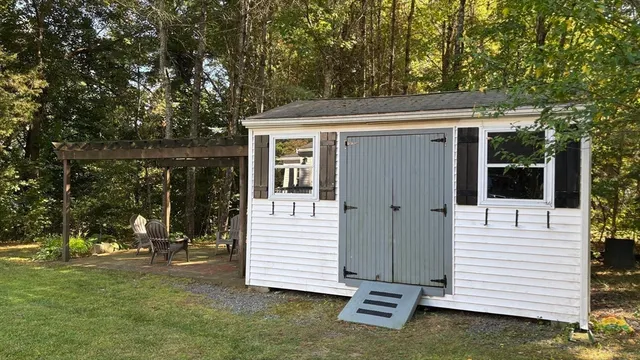 a view of a white house with a yard