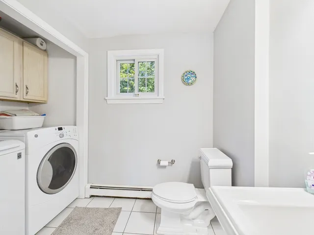 a white toilet sitting next to a bathroom sink and vanity