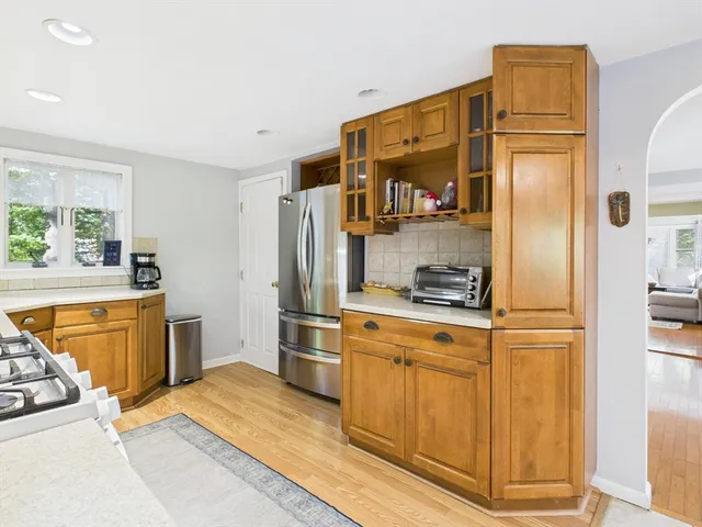 a kitchen with stainless steel appliances granite countertop a refrigerator and a stove top oven