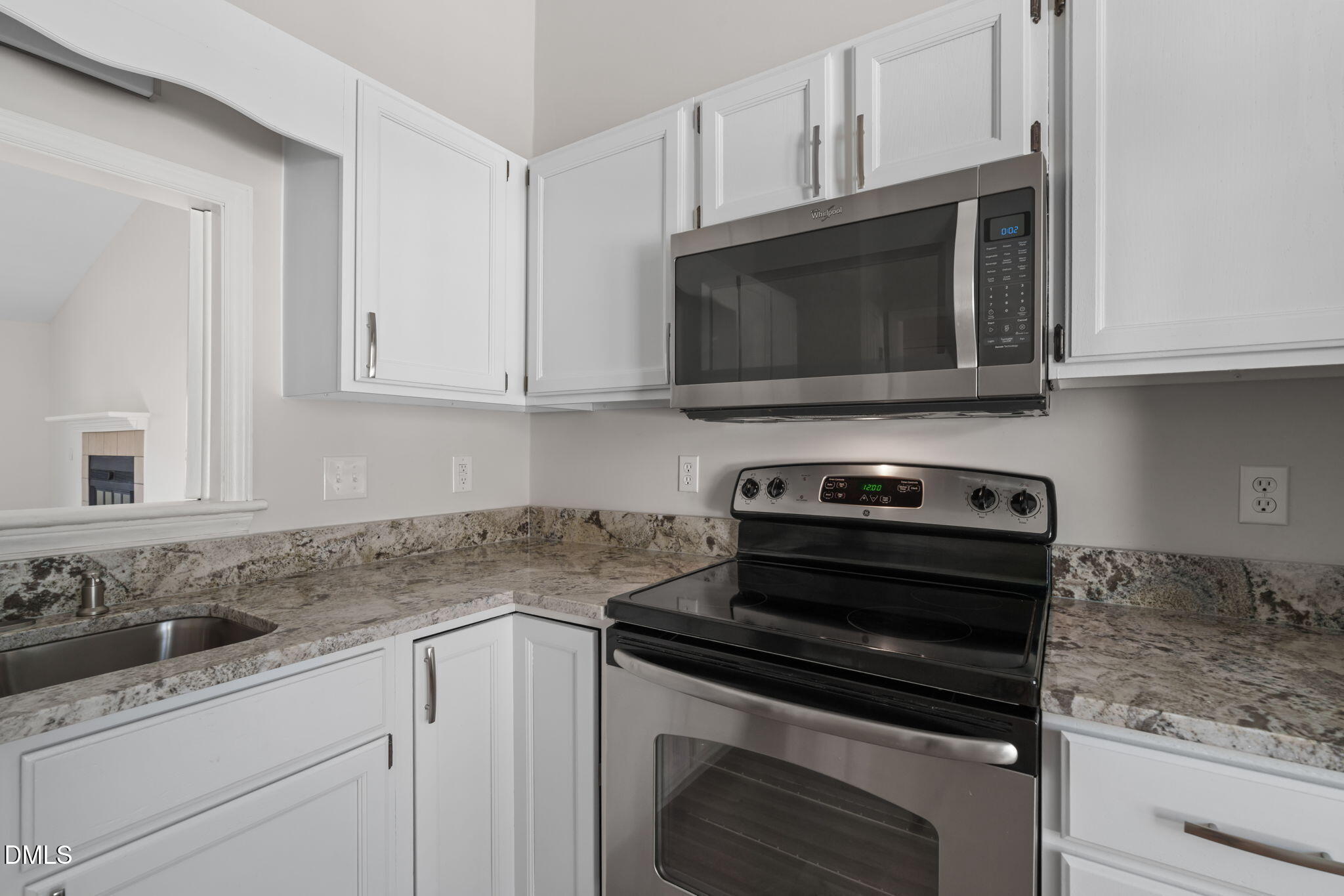 1424 Mapleside Court Raleigh, NC 27609 - Photo 17 of 72 a kitchen with granite countertop white cabinets and appliances