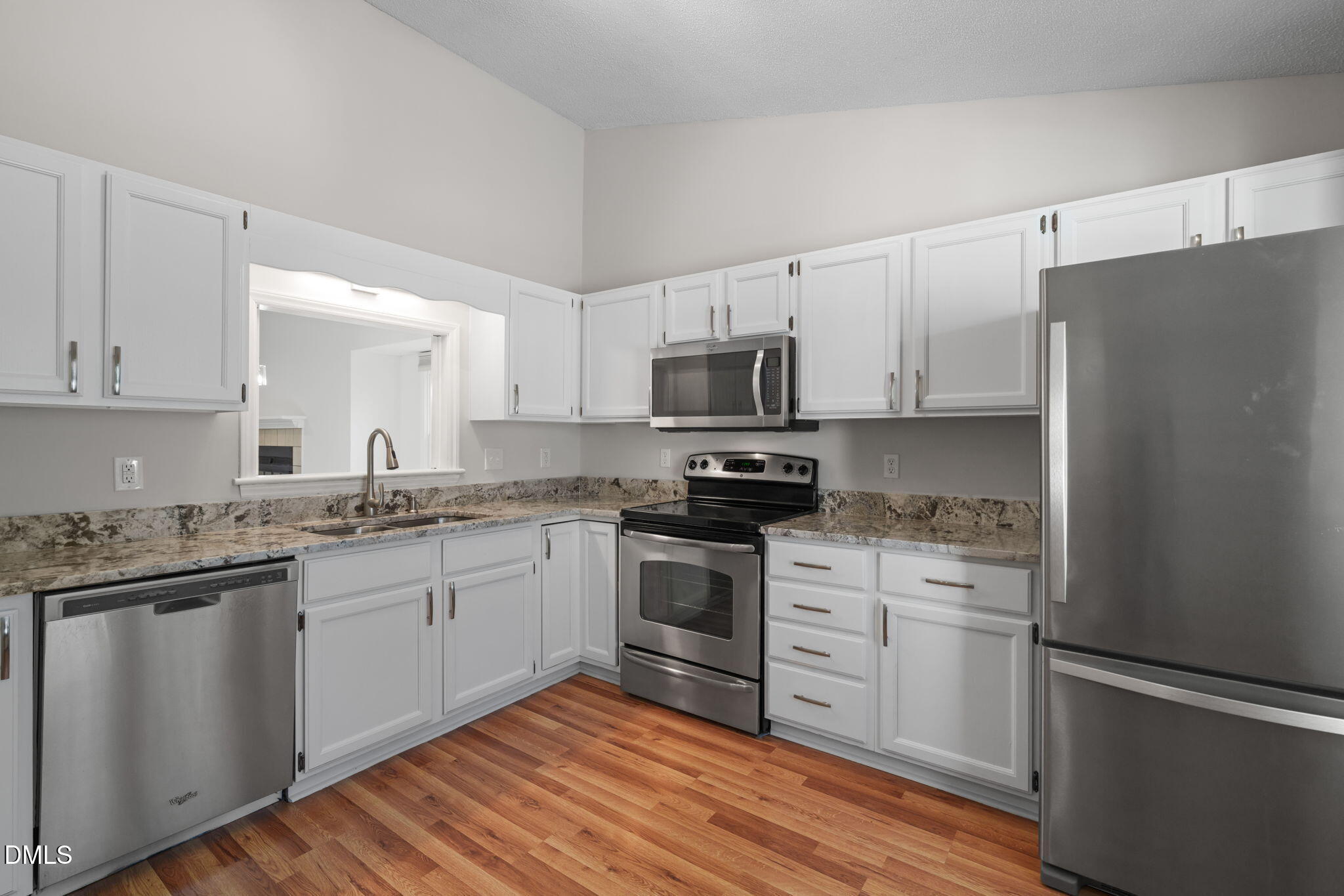 1424 Mapleside Court Raleigh, NC 27609 - Photo 2 of 72 a kitchen with granite countertop white cabinets and white appliances