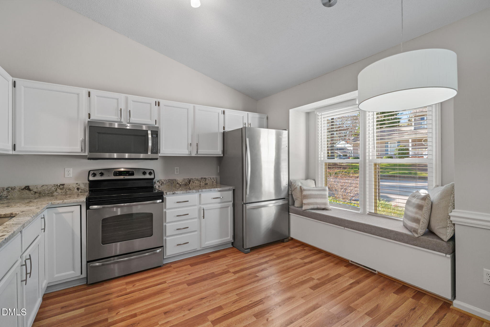 1424 Mapleside Court Raleigh, NC 27609 - Photo 21 of 72 a kitchen with stainless steel appliances a stove a refrigerator and a microwave